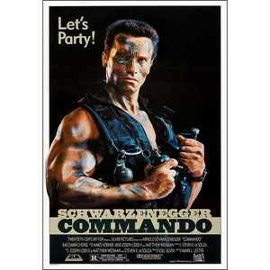 May include: A film poster for the action movie Commando starring Arnold Schwarzenegger. The poster features a close-up of Schwarzenegger holding a gun and grenade, with the title "Schwarzenegger Commando" in large, bold letters. The tagline "Let's Party!" is displayed at the top of the poster.