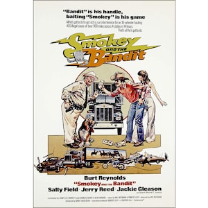 May include: A movie poster for the film "Smokey and the Bandit" starring Burt Reynolds, Sally Field, and Jerry Reed. The poster features a cartoon illustration of a truck driver, a woman, and a sheriff standing in front of a semi-truck. The text on the poster reads "Bandit" is his handle, baiting "Smokey" is his game. All he's gotta do to get rich is run interference for an 18-wheeler hauling 400 illegal cases of beer 900 miles across 4 states in 14 hours. That's all he's gotta do.