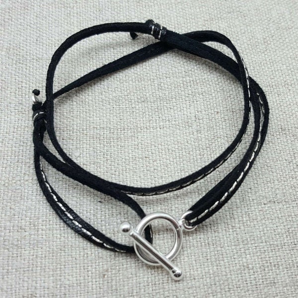 Clasp bracelet and double-tower leather link