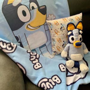 Plushie Blue or Bingo Heeler Dog 3 piece set. Includes 1 blanket, 1 plushie doll, and 1 pocket pillow. Limited Quantities and Free Shipping