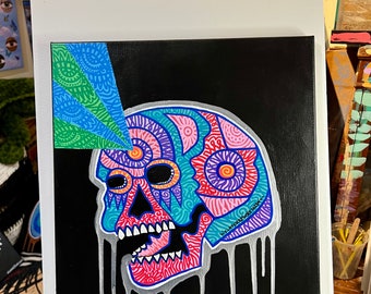 May include: A colorful skull painting with a black background. The skull is decorated with intricate patterns in pink, blue, green, and purple. The skull has a silver drip effect. The artist's signature is visible on the right side of the skull.