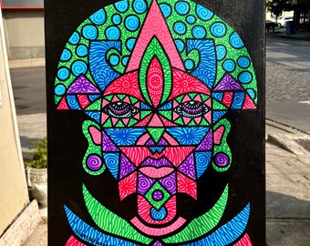 May include: A colorful geometric abstract painting on a black canvas. The painting features a stylized face with green, blue, pink, and purple details. The face is surrounded by a border of green and blue swirls.