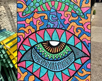 May include: A colorful abstract painting on canvas with a large eye in the center surrounded by swirling patterns and a green mushroom-like shape at the top. The painting is signed "Wildeofthewoods 23" in the bottom left corner.