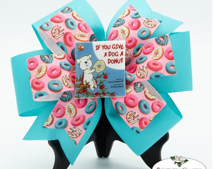Featured listing image: Dog with a Donut Stacked Pinwheel Bow | Handmade Resin Book Center Available in English or Spanish | Storybook Bow for Little Readers