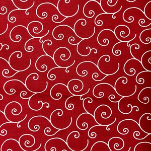 May include: A close-up of a red fabric with a repeating white swirl pattern. The swirls are stylized and create a flowing, organic design. The fabric has a textured appearance, suggesting a woven material. The overall effect is decorative and visually appealing.