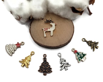 May include: Assortment of six Christmas charms, including a gold reindeer, a white and red Christmas tree, a gold Christmas tree, a copper Christmas tree, a green and red Christmas tree, and a silver Christmas tree.