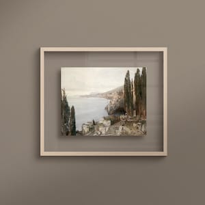 May include: A framed painting depicting a coastal landscape with a view of a bay and a town on a hillside. The painting features a group of cypress trees in the foreground and a single figure standing on a set of stone steps.