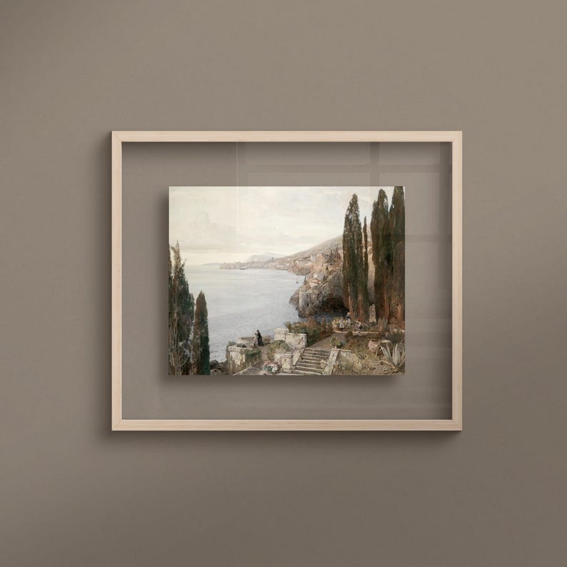 May include: A framed painting depicting a coastal landscape with a view of a bay and a town on a hillside. The painting features a group of cypress trees in the foreground and a single figure standing on a set of stone steps.