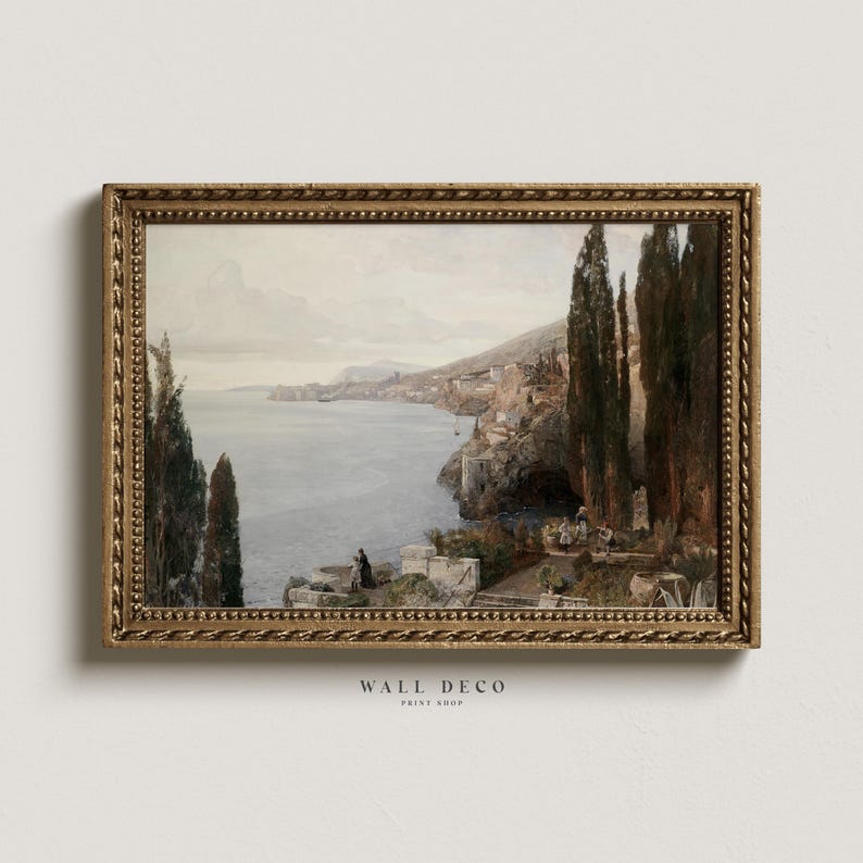 May include: A framed painting of a seascape with a coastal town in the distance. The painting is in a gold frame with a decorative border. The painting is set against a white wall.