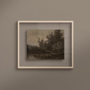 May include: A framed landscape art print in sepia tones, depicting trees and water. The artwork is presented within a white, square frame, offering a minimalist design. The print conveys a sense of peace and natural beauty, suitable for various interior styles.