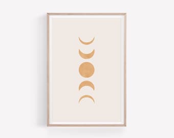 May include: A framed art print featuring a minimalist design of the phases of the moon. The artwork showcases a series of golden-yellow crescent and circular shapes against a cream-colored background. The print is encased in a light-colored wooden frame.