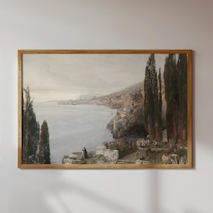 May include: A framed watercolor painting depicting a coastal scene with a town built into the hillside overlooking a calm sea. The painting features a muted color palette with shades of blue, gray, and brown.