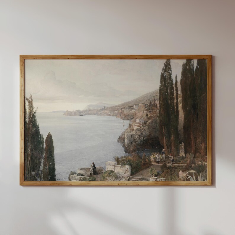 May include: A framed watercolor painting depicting a coastal scene with a town built into the hillside overlooking a calm sea. The painting features a muted color palette with shades of blue, gray, and brown.
