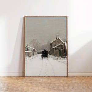 May include: A framed print depicting a snowy winter scene. A horse-drawn carriage moves along a snow-covered road, with buildings and trees on either side. The artwork uses muted tones of grey, white, and brown, creating a nostalgic atmosphere.