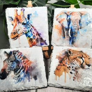 May include: Set of four watercolour animal coasters featuring a giraffe, elephant, zebra and cheetah. Each coaster is made of slate and features a unique watercolour design.