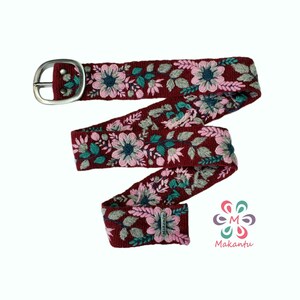 May include: A burgundy woven belt with a silver buckle and floral embroidery in shades of pink, green, and blue.
