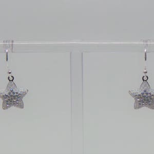 Sterling silver hook earrings featuring Swarovski star pandant. image 4