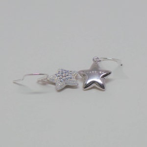 Sterling silver hook earrings featuring Swarovski star pandant. image 3