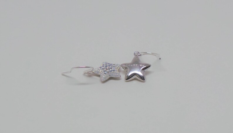 Sterling silver hook earrings featuring Swarovski star pandant. image 3