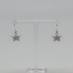 Sterling silver hook earrings featuring Swarovski star pandant. image 6