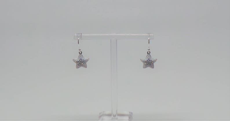 Sterling silver hook earrings featuring Swarovski star pandant. image 6