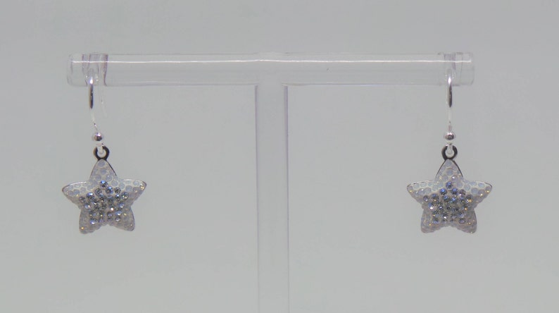 Sterling silver hook earrings featuring Swarovski star pandant. image 5