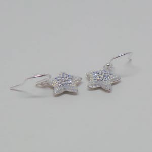 Sterling silver hook earrings featuring Swarovski star pandant. image 2