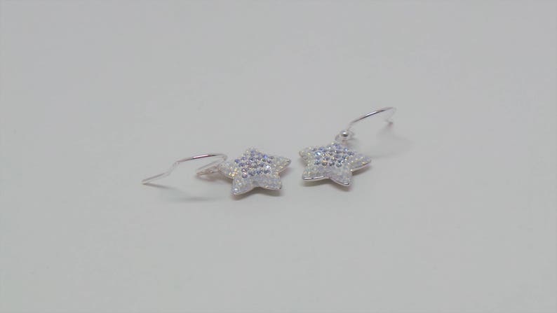 Sterling silver hook earrings featuring Swarovski star pandant. image 2