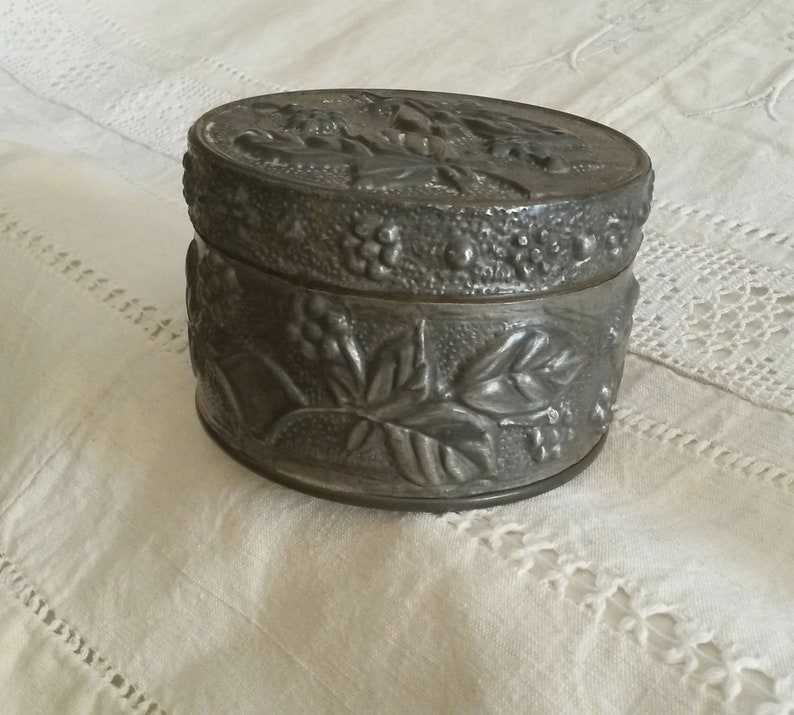 Old Tin decoration of flowers and leaves in relief vintage Silver box