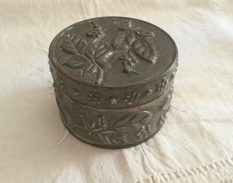Old Tin decoration of flowers and leaves in relief vintage Silver box
