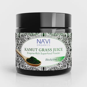 May include: A black jar of Navi Organics Kamut Grass Juice, an enzyme-rich superfood powder. The label features a white oval with text and a wooden spoon holding green powder. The jar has a black lid and a decorative border.