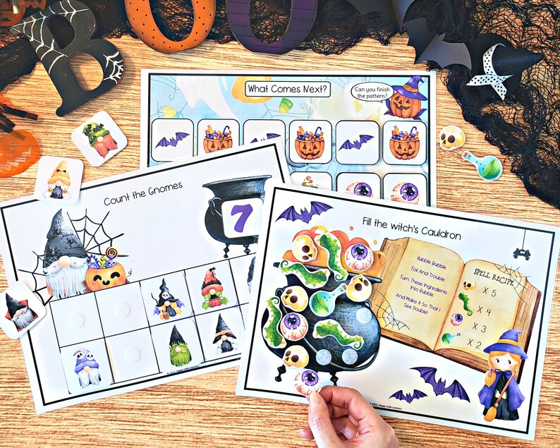 May include: A set of Halloween-themed educational activity sheets for kids. The sheets feature gnomes, pumpkins, bats, cauldrons, and eyeballs. The sheets include activities like counting, matching, and spelling.