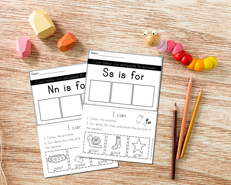 May include: Two printable worksheets for kids to learn the letters N and S. Each worksheet has a title, "Nn is for" and "Ss is for", with three blank boxes for pictures. Below the boxes, there are instructions to color, cut, and paste pictures. The instructions include a list of words that start with the letter, such as "nest", "nose", "note" for the letter N and "snail", "sock", "star" for the letter S.