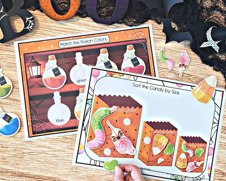 May include: A Halloween-themed educational activity set with two printable worksheets. The first worksheet features a potion matching game with colorful bottles and labels. The second worksheet features a candy sorting game with bags labeled "large candy", "medium candy", and "small candy".
