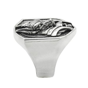 May include: A silver ring with a detailed dragon design on the face. The ring has a octagonal shape and a wide band.