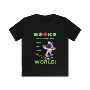 May include: Black t-shirt featuring a cartoon astronaut surrounded by books. The shirt has the text "BOOKS CAN TAKE YOU OUT OF THIS WORLD!" in green, blue, and red. The astronaut is wearing a white spacesuit.