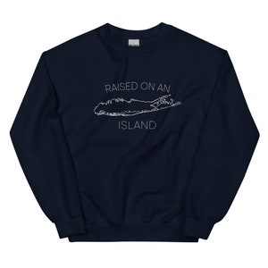 May include: Navy blue sweatshirt with a white outline of Long Island and the text "RAISED ON AN ISLAND".