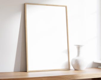 May include: A wooden shelf with a white vase and a framed picture. The shelf is against a white wall.