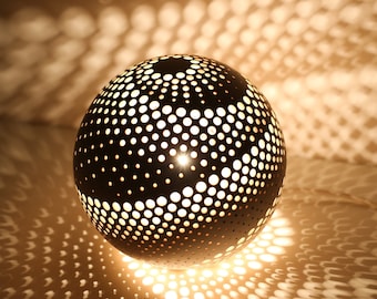 Minimalistic ceramic sphere lamp for warm ambiance in your home. Beautiful shadow-play light-sculpture