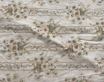 May include: A white fabric with a repeating pattern of brown floral bouquets. The bouquets are arranged in vertical rows and are tied with brown ribbons.