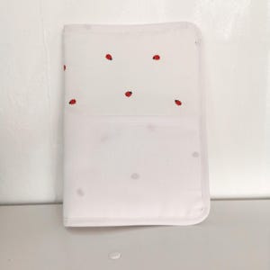 Health book cover to embroider in cross stitch, ladybugs on a white background