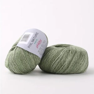 May include: Two balls of green yarn labeled "PHIL NATURE" with the text "Avec lin" and "phildar" on the label.