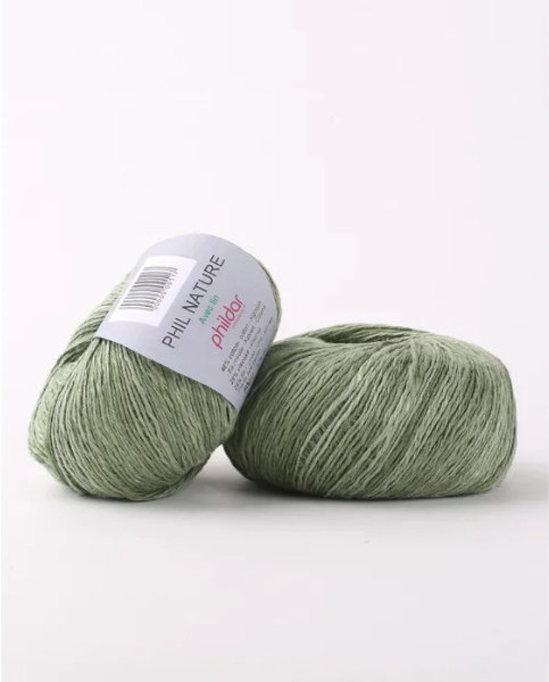 May include: Two balls of green yarn labeled "PHIL NATURE" with the text "Avec lin" and "phildar" on the label.