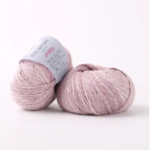 May include: Two skeins of pale pink Phil Nature yarn, a blend of linen and cotton, with a label that reads "Phil Nature" and "Phildar".