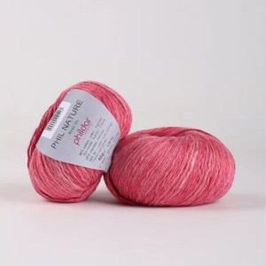 May include: Two balls of pink Phil Nature yarn with the label "Avec l'in Philodor" and details about the yarn composition and care instructions.