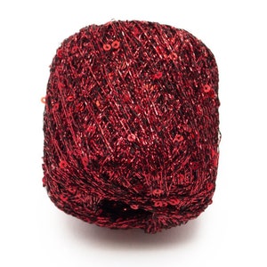 May include: A ball of red metallic yarn with red sequins woven throughout.