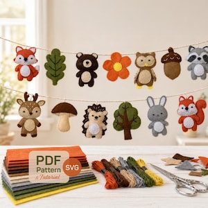May include: A felt woodland animal banner with a fox, bear, owl, and other forest creatures. The banner is strung on a twine with a stack of felt squares, embroidery floss, and a pair of scissors.