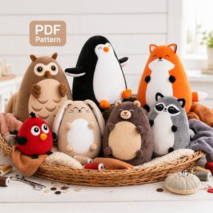 May include: A collection of plush animal toys, including an owl, penguin, fox, raccoon, bear, bunny, and bird, arranged in a woven basket. The toys are various colors and sizes, with embroidered details. The image includes the text "PDF Pattern".