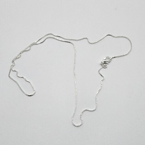 May include: A silver chain necklace with a lobster clasp.