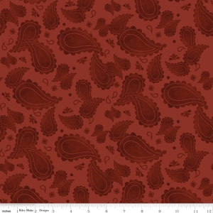 May include: Red paisley fabric with a repeating pattern of paisley shapes in a darker shade of red. The fabric is textured and has a slightly distressed look.